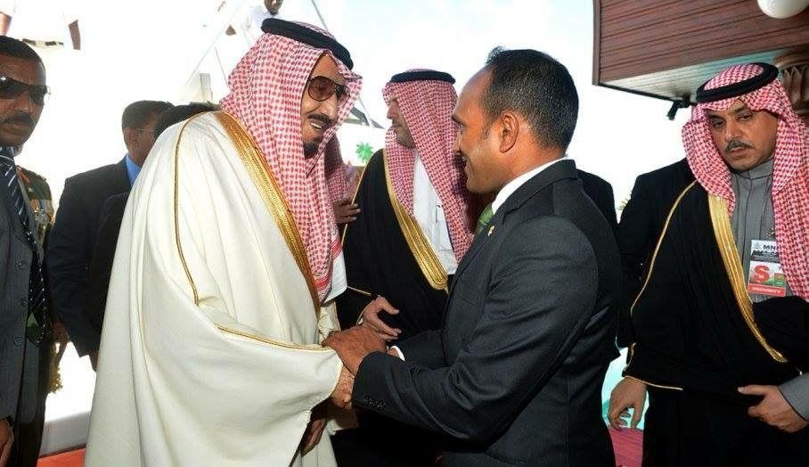 Dr Jameel greeting hosts in traditional Gulf dress on arrival.
